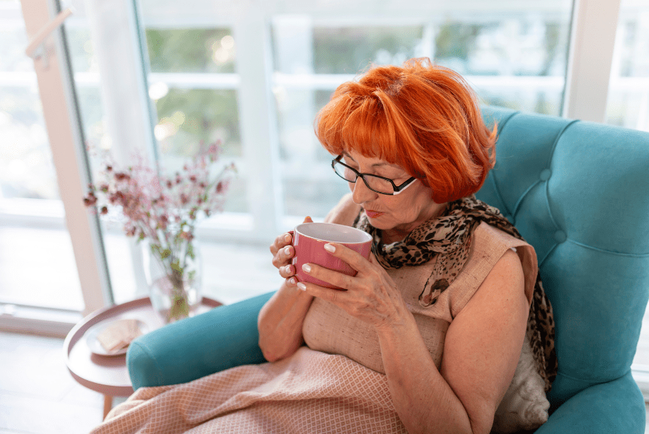 Elderly Woman sitting with a cup of tea