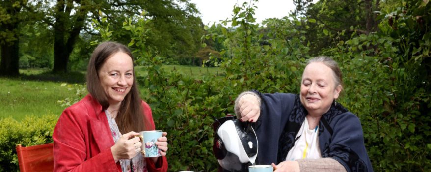 Mother and Daughter sitting in the garden having tea with their Uccello Kettle