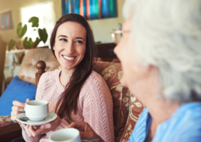 Grandchild enjoying a cup or tea with her grandmother