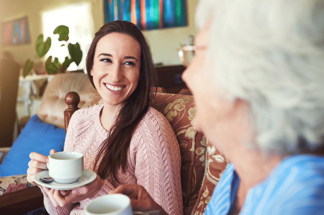 Grandchild enjoying a cup or tea with her grandmother