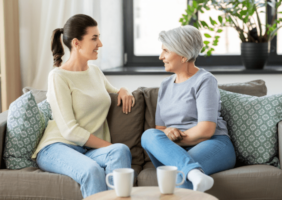 Adult daughter talking to her elderly mother