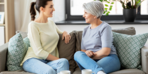 Adult daughter talking to her elderly mother