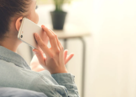 Woman with back to the camera on the phone (Photo Cred - Canva)