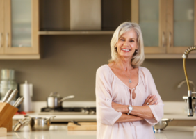 Elderly Woman standing in a modern style kitchen