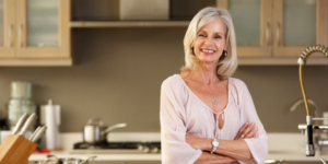 Elderly Woman standing in a modern style kitchen