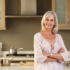 Elderly Woman standing in a modern style kitchen