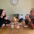 Grandmother and Granddaughter having a cup of tea and biscuits together