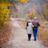 Elderly couple walking a path in the woods