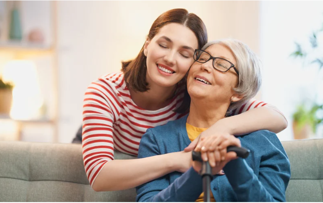 Adult daughter hugging her elderly mother (Photo Cred: Canva)