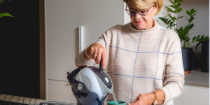 Elderly woman using the tilt-to-pour Uccello Kettle